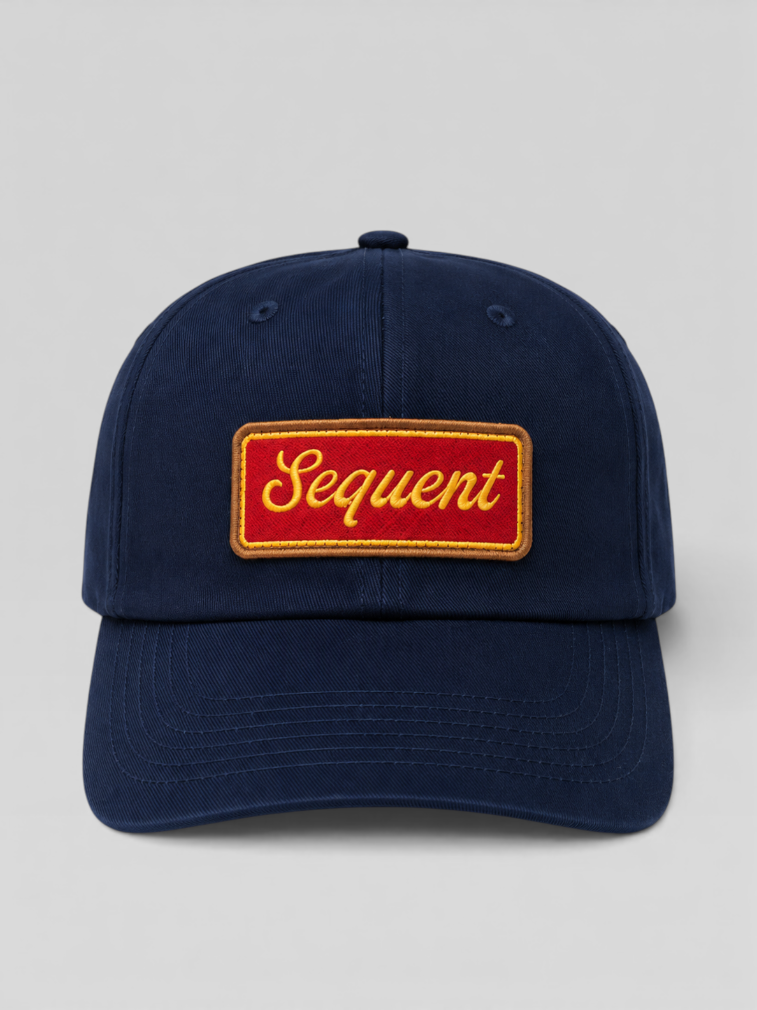 Navy blue cap with a red and yellow 'Sequent' logo embroidered on a light gray background