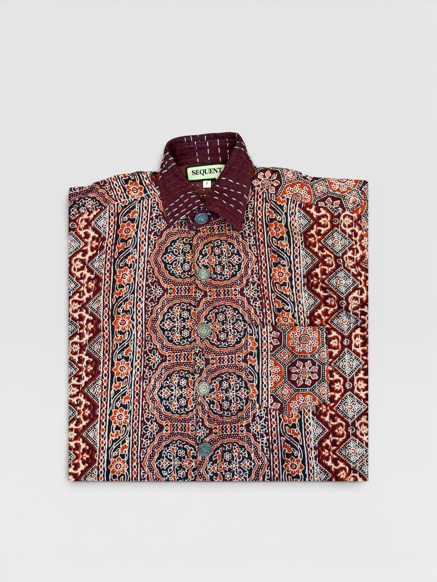 Traditional patterned Ajrakh kantha shirt with a brand label 'Sequent' on a light gray background