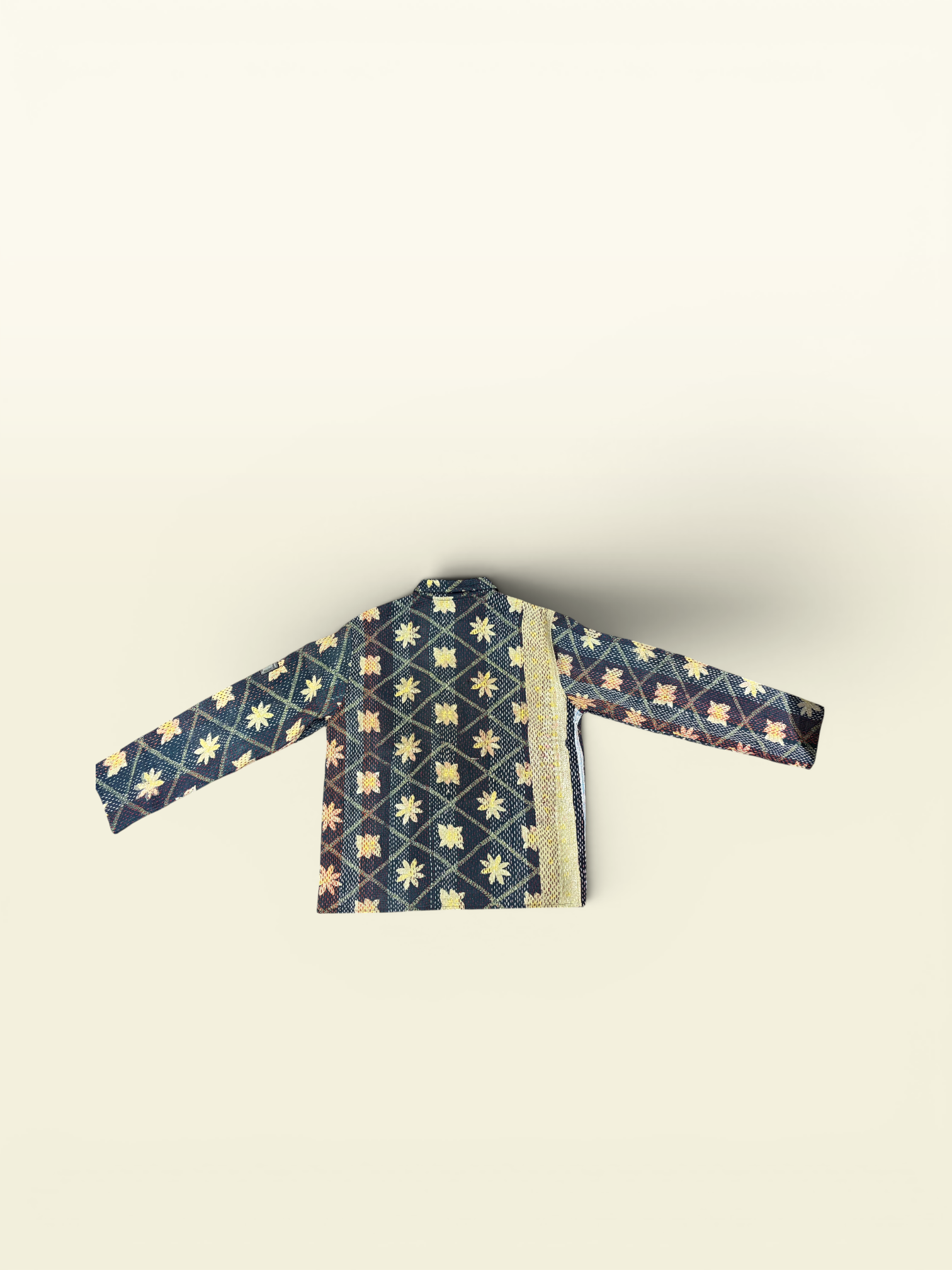 A Vintage Kantha jacket featuring a navy blue and gold geometric pattern with a beige border, set against a solid cream background.