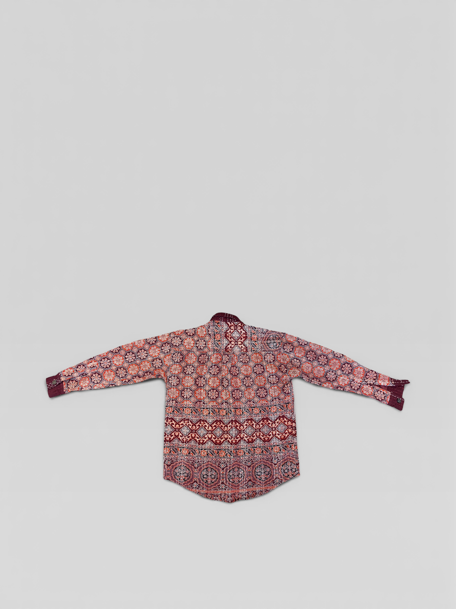 Floral Ajrakh Kantha patterned shirt on a light gray background