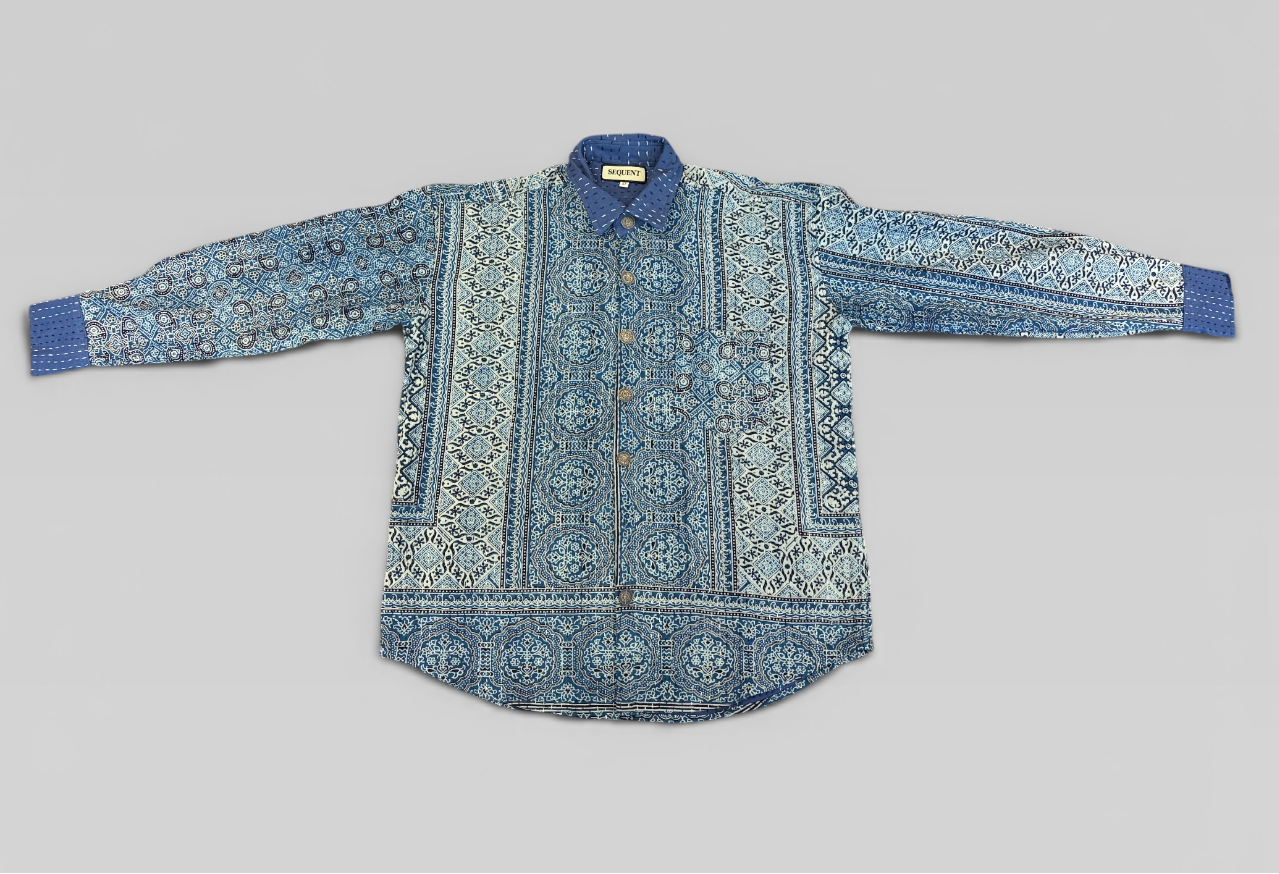 Blue hand painted Ajrakh Kantha shirt on a gray background
